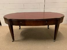 A mahogany coffee table of a oval shape with inlay and drawers to sides (H45cm W107cm D56cm)