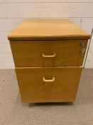 A light oak filing cabinet