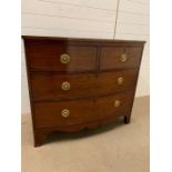 A mahogany chest of drawers with brass ring handles (H94cm W107cm D55cm)