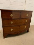 A mahogany chest of drawers with brass ring handles (H94cm W107cm D55cm)