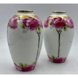 A pair of Cacilie vases decorated with roses