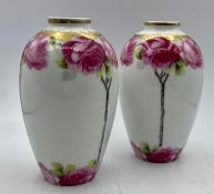 A pair of Cacilie vases decorated with roses