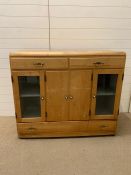A antique pine kitchen unit with glazed doors to side, with drawers to top and bottom (H98cm