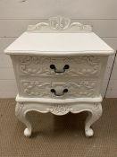 A white bedside with decorative scrolls to front (H66cm W50cm D40cm)