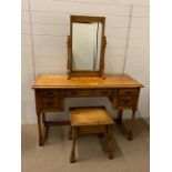 A Stuart Linford burr oak dressing table with drawers to side and centre along with a stool and