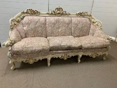 A three seater Silik baroque sofa with scrolled arms and feet