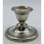 A Silver squat candlestick by James Deakin & Sons Chester 1913, 6 cm high.