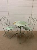 A garden metal bistro set in pale green