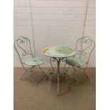 A garden metal bistro set in pale green