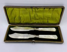 A cased pair of mother of pearl handled fish knives by WB & Co