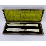 A cased pair of mother of pearl handled fish knives by WB & Co