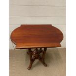 A mahogany side table on four legs and middle centre piece (H67cm W59cm D38cm)