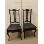 A Pair of Mahogany dining chairs with pierced splat backs.