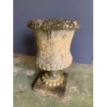 An urn planter on base