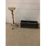 A white painted wrought iron flower pot stand and small planter