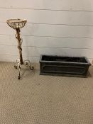 A white painted wrought iron flower pot stand and small planter