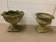 Two stone garden planter on plinths