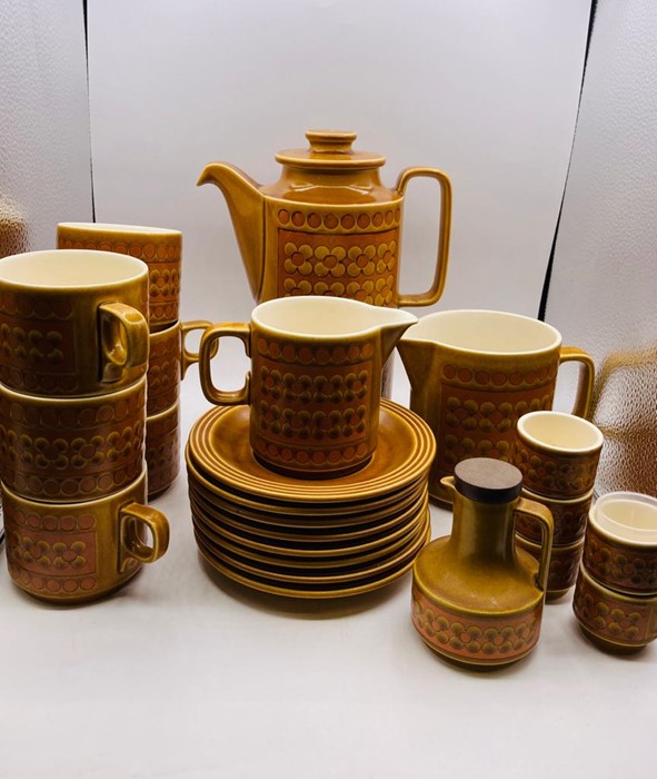 A 1970's Hornsea Pottery "Saffron" tea service to include, six cups and eight saucers, tea pot, milk