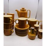 A 1970's Hornsea Pottery "Saffron" tea service to include, six cups and eight saucers, tea pot, milk