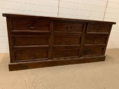 A hardwood sideboard with nine drawers 180cm L x 50cm D x 80cm H