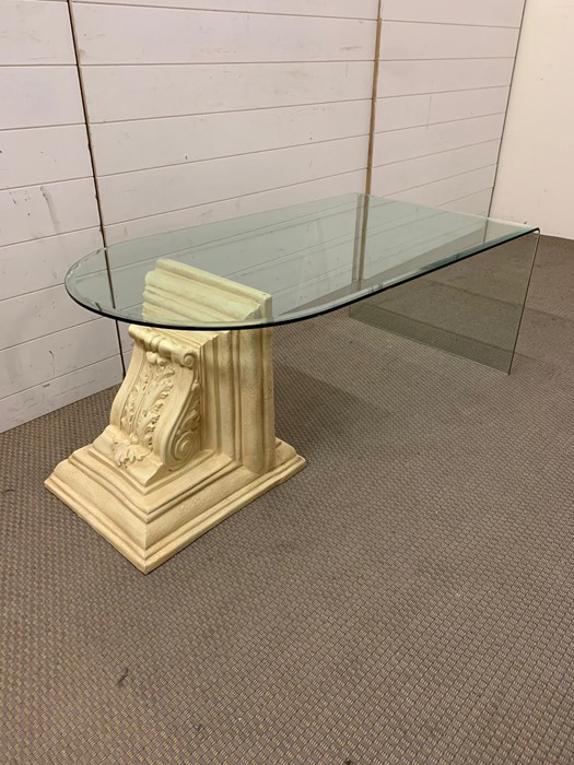 A contemporary glass coffee table with a decorative scrolled end (H49cm W120cm D65cm)