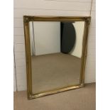 A large gilt frame mirror with scrolled detail to corners (H130cm W107cm)