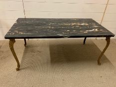 A marble topped coffee table on brass scrolled feet (H43cm W102cm D51cm)