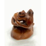 Japanese antique wooden netsuke of two frogs dancing with signature "Ishikawa"