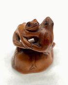 Japanese antique wooden netsuke of two frogs dancing with signature "Ishikawa"