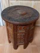 An INDIAN wooden carved occasional table, (40 high; 38 diam).