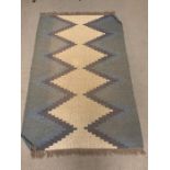 A woven rug with diamond pattern (197cm x 200cm)
