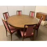 A Mid Century teak style dining table and chairs (H78cm Dia147cm)