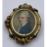 A rotating Pinchbeck brooch with miniature portraits of a Gentleman and a Lady "Containing a