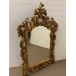 A wall hanging gilt mirror with scrolled details (H165cm W110cm)
