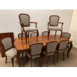 A mahogany dining table with string inlay detail to top, eight chairs and two carvers (One extension
