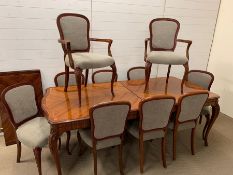 A mahogany dining table with string inlay detail to top, eight chairs and two carvers (One extension