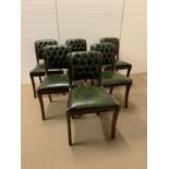 A set of six green button back leather chairs