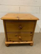 A two drawer pine side table or bedside table (H48cm W46cm D39cm)