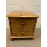 A two drawer pine side table or bedside table (H48cm W46cm D39cm)