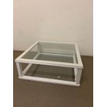 A glass coffee table in a white painted wooden frame (H35cm 92cmsq)