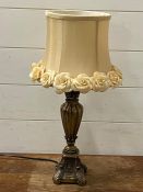 A contemporary metal based table lamp with a floral shade