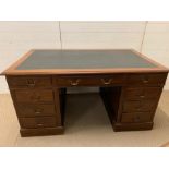 A large oak pedestal desk with leather top (H76cm W150cm D91cm)