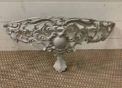 An ornate metal wall sconce in the form of a shelf