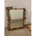 A giltwood wall mirror with rectangular plate and openwork scroll frame AF (75cm x 90cm)