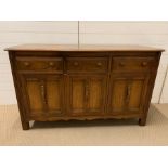 A Ercol Elm sideboard (H86cm W147cm D53cm)