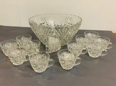 A cut glass punch bowl and twelve cut glass cups