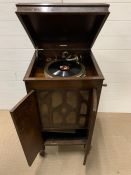 A wind up gramophone in a mahogany cabinet