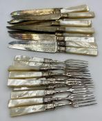 A set of Mappin & Webb mother of pearl handled knives and forks (Set of twelve but missing one