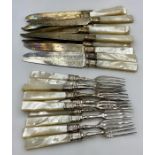 A set of Mappin & Webb mother of pearl handled knives and forks (Set of twelve but missing one