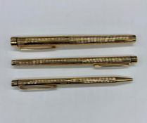 A Sheaffer gold plated pen set to include ink pen, roller ball and ball point.